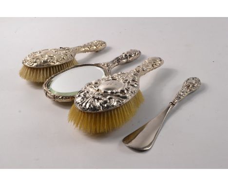 A vintage silver (Chester) dressing table set comprising of 2 hairbrushes, hand mirror and a silver shoe horn - condition: da