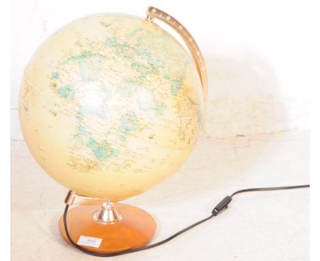 A vintage 20th century rotating desk top world globe. Spherical form with curved metal arm support on a wooden circular base.