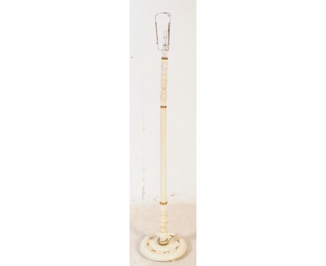 An early 20th century painted floor standing standard lamp. Light fixing to top, turned central column with foliate carved de