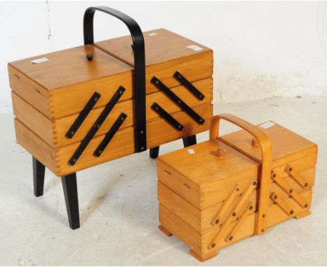 British Modern Design - Two mid 20th century cantilever sewing boxes. With carry handle to top, three tiers. Raised on bracke