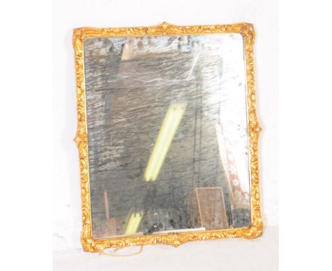 A vintage 20th century rectangular gilt wall mirror. With central glass panel and gilt frame with scroll / carved design. Mea