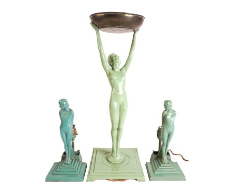 AN ART DECO GREEN PAINTED SPELTER FIGURAL TABLE LAMP AND A PAIR  OF TABLE LAMPS (3)With brass dished support, indistinctly st