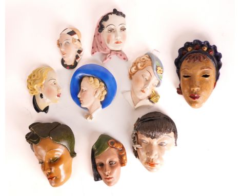 A GROUP OF ART DECO STYLE WALL MASKS (9)Including two by Royal Dux, one of a woman with a yellow butterfly on her shoulder, 2