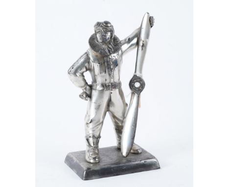 A CHROME PLATED AVIATOR TABLE LIGHTERModelled as a pilot holding a propellor, circa 1930s, 27.5cm high