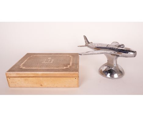 A CHROME PLATED DUNHILL ‘SABRE JET’ AEROPLANE TABLE LIGHTER (2)Circa 1950s 16.5cm long; Together with an engine milled gilt m