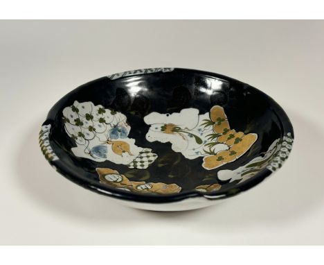 An Archie McCall (Scottish 1951-) stoneware decorative bowl, with green, black and blue glaze and gold luster, signed verso. 