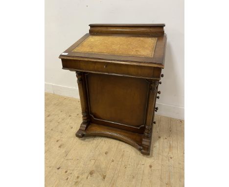 Mahogany davenport with a shaped storage compartment above a sloping lid with an inset leather, opening to reveal a shelf abo