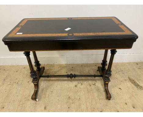 Aesthetic movement ebonised and burr walnut card table, late 19th century, with a flod over and swivel blue baize lined top, 