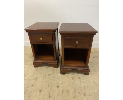 Pair of Winsor mahogany bedside tables, with moulded tops above a frieze drawer with an open shelf below, standing on bracket