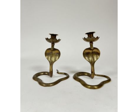 A pair of cast brass cobra candlestick holders with decorative engraving and lotus flower detailed bobeches (h. 20cm x w. 17c