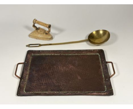An Arts and Crafts style copper hammered twin handled (engraved JJ verso) (l-45cm), a large brass ladle and a vintage cast fl