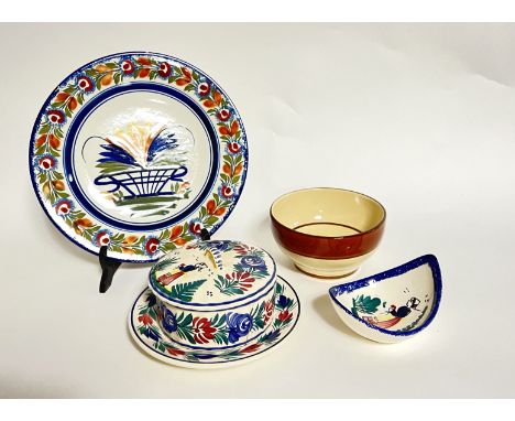 A selection of Quimper pottery comprising, a salad plate with lotus flower detail and floral border (d. 24.5cm), a smaller pl