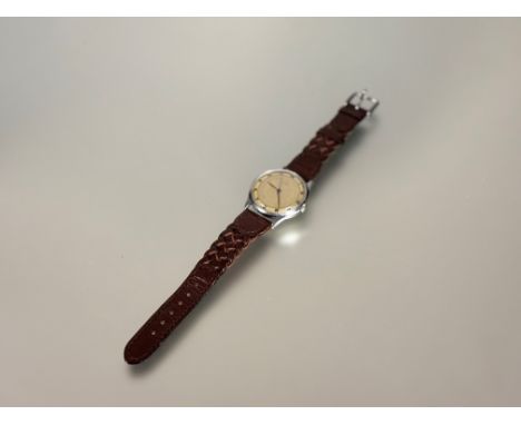 A vintage Gents Omega wristwatch with gilt dial and Arabic numerals and seconds hand complication 17 jewel manual wind moveme