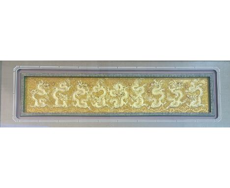 A modern Chinese nine gold dragon figures chasing a peal mounted panel, in a glazed frame. (26.5cmx122cm)