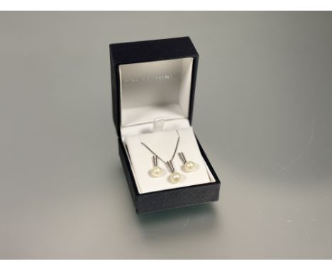 A 18ct white gold pendant and pair of matching drop earrings all with cultured pearl drop on tapered mount set five round bri