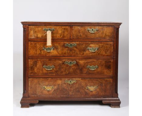 having a rectangular cross banded top above two short over three long graduating drawers with brass swan neck handles togethe