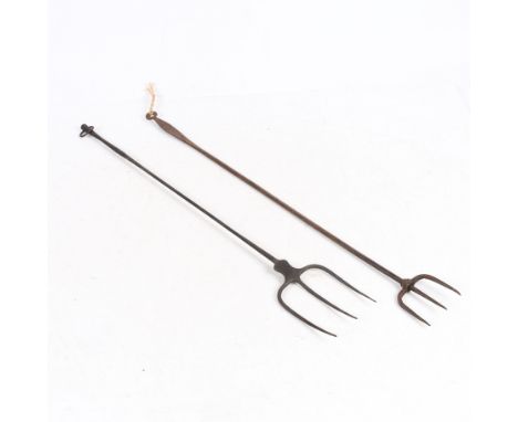 both of trident form, one wrought iron the other steel, the largest 59cm long.