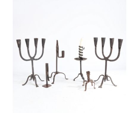 to include a pair of four branch candelabra raised on four pad feet, a "rat de cave" style candlestick with drip pan and trip