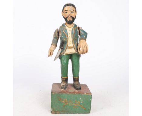In the form of a bearded man in blue coat, green trousers and with a dagger, on block base, with pinned adjustable arms, 40cm