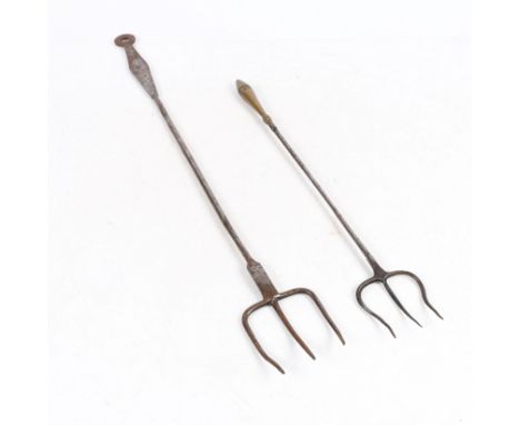 both of trident form and having cylindrical stems one terminating to a brass handle the other with a flat steel handle, the l