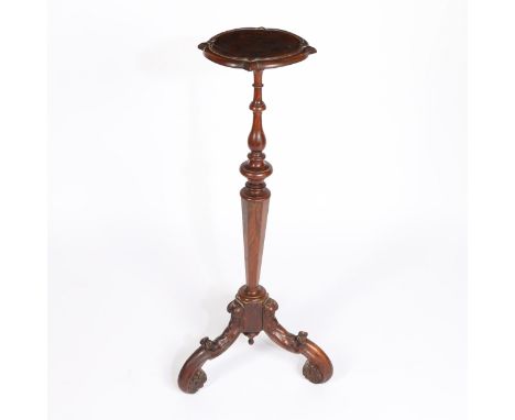 having a burr walnut top above a knopped and faceted tapering column raised on scroll carved tripod legs terminating to flowe