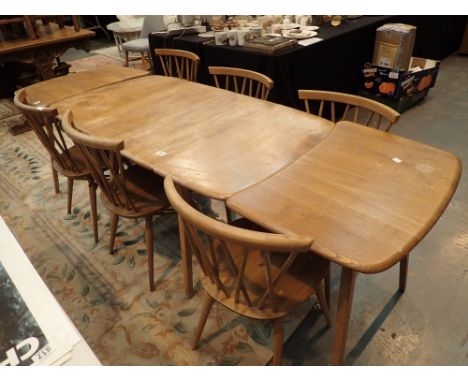 Ercol light elm dining table with two tripod end pieces and six stickback chairs with popper seat pads