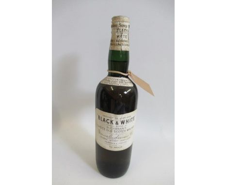 A bottle of 1950s(?) "BLACK &amp; WHITE" Buchanan's choice old scotch whisky, with white label and clip cap (Est. plus 21% pr