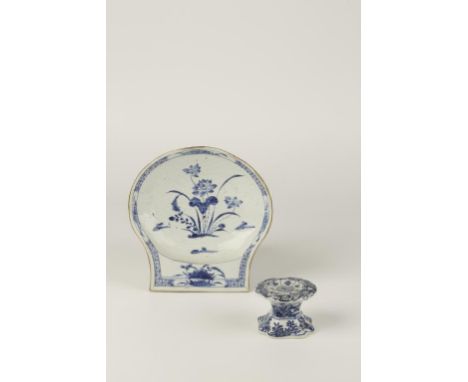 A CHINESE BLUE AND WHITE SHELL-SHAPED DISH painted with flowers and foliage within formalised cellular and foliate borders, 1