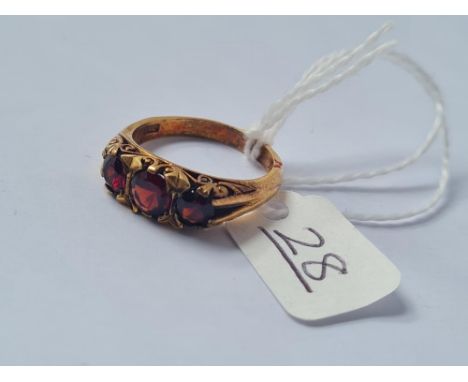 A three stone garnet ring in 9ct - size P - 5.2gms