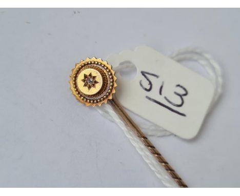 A stick pin with a single diamond in 15ct gold