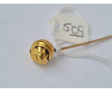 A stick pin set with a ball of string terminal in high carat gold 