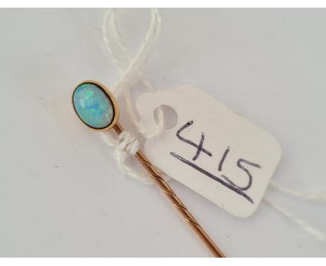 A opal mounted stick pin in gold 