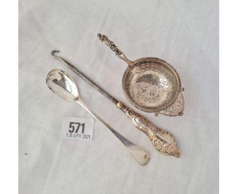 A late Victorian tea strainer with apostle handle B'ham 1899 a mustard spoon and a mounted button hook 47 gms weighable 