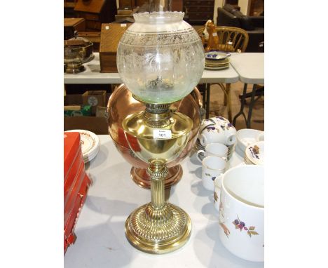 An oil lamp, the brass reservoir on reeded column and circular base, with etched opaque and clear glass shade, 65cm high over