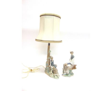 A LLADRO FIGURAL LAMP BASE  modelled as a girl sitting beside a tree trunk, 30cm high (excluding electrical fittings); and an