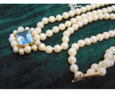 A THREE ROW UNIFORM CULTURED PEARL NECKLACE to an aquamarine and cultured pearl clasp, the 51/51/53 pearls of approximately 6