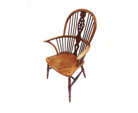 A WINDSOR STICK BACK ELBOW CHAIR with wheel back splat and dished seat