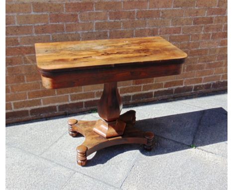 A VICTORIAN ROSEWOOD 'D' SHAPED FOLD OVER CARD TABLE  raised on a shaped pedestal with incurving platform base. 74cm high, 90