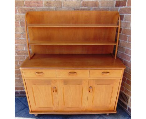 A LIGHT ERCOL STYLE DRESSER  the rack with two shelves, above base with three drawers and cupboard with bi-folding door, 121c