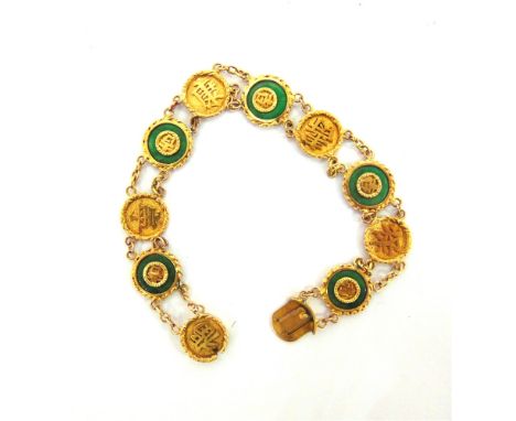 A CHINESE JADE BRACELET stamped 'Y.C.' and '18K', the circular panels alternating with a jade circle around a character and c