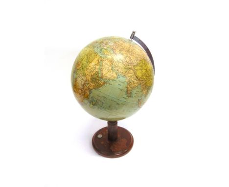 A 13' TERRESTRIAL GLOBE ON STAND  naming Persia and Iran amongst the countries, the stained beech stand inset with compass, 5