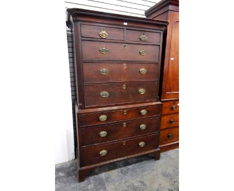 George III oak chest on chest with dentil cornice, the upper section with two short and three long graduated drawers with ree