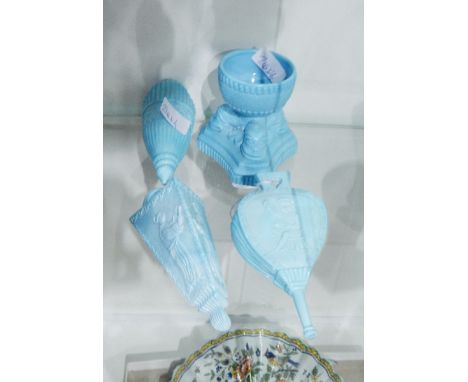 Two Sowerby blue pressed glass wall pockets, one of triangular design decorated with oriental figures, the other modelled as 