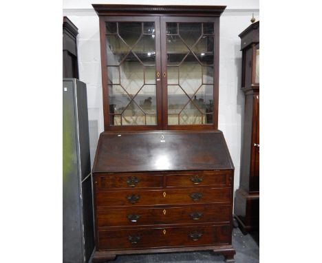 George III mahogany bureau/bookcase with dentil cornice over two astragal glazed doors, over fall-front bureau with fitted in
