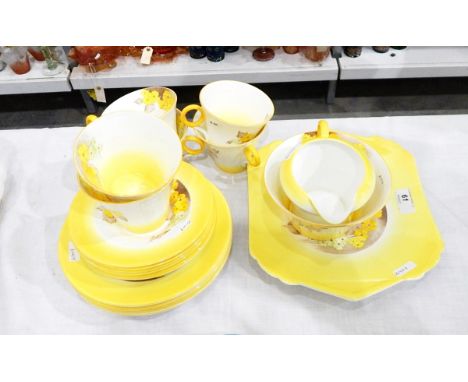 Shelley tea service of white ground with yellow handpainted borders, transfer-printed and yellow and green highlighted primro