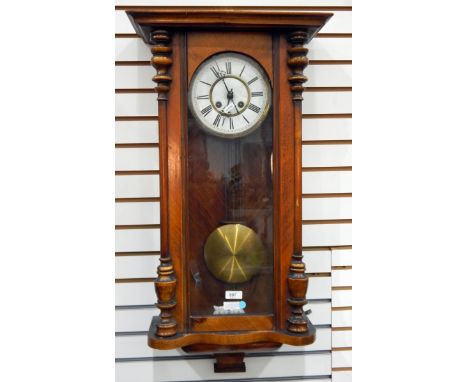 German walnut and glazed wall clock with enamel dial, brass beaded mounts, having eight-day gong striking movement, glazed do