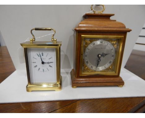 Carriage clock in lacquered brass case, the dial with Roman numerals and inscribed "Martin & Co, Cheltenham" with quartz move