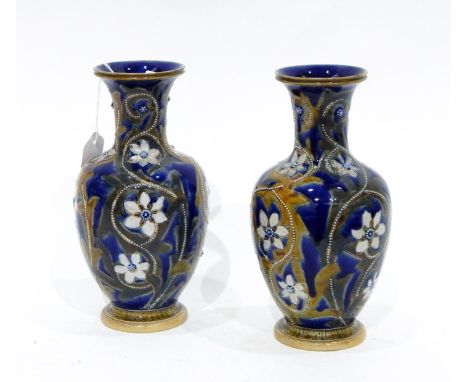 Pair of Doulton Lambeth baluster-shaped vases with blue ground, incised stylised floral and foliate decoration with raised en