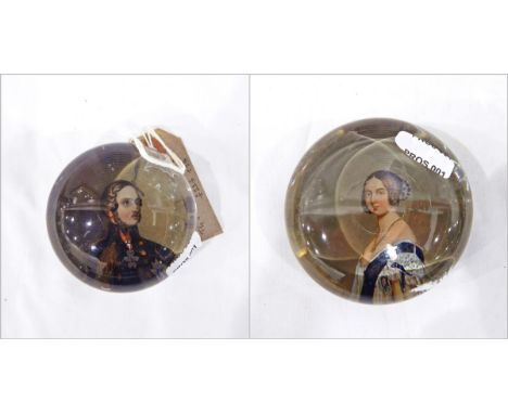 Two 19th century glass paperweights, one with a portrait of Prince Albert beneath the glass dome, the other with a portrait o