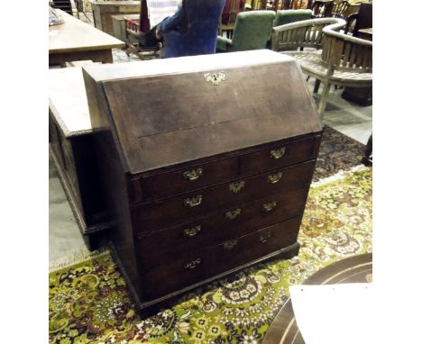 George III oak bureau, the fall-front revealing a fitted interior with column compartments flanking a central door, over two 